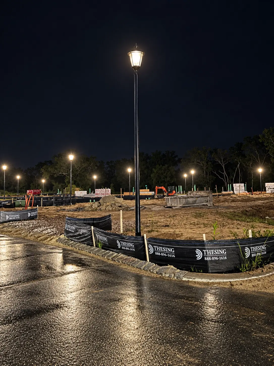 Decorative site-lighting pole operating during construction of a residential development
